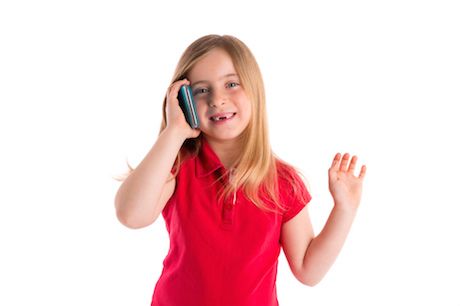 blond indented kid girl smiling talking smartphone phone on white background